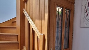 A wooden staircase leading to a door with glass panels.