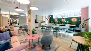 A modern interior with a dining area, kitchen, and seating space.