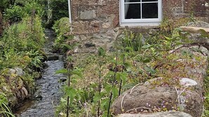 A stone building with a window and a small stream running through a garden. - Annie's Cottage, Wellington
Stunning Cottage in lake District National Park (Seascale)