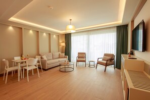 Superior Penthouse, Pool View | Living area | 55-inch Smart TV with satellite channels - Casa Lumar Luxury Lodging - Adults Only (Fethiye)