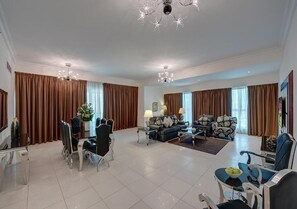 Relax in this stylish living area with a dining table, sofa, and coffee table.