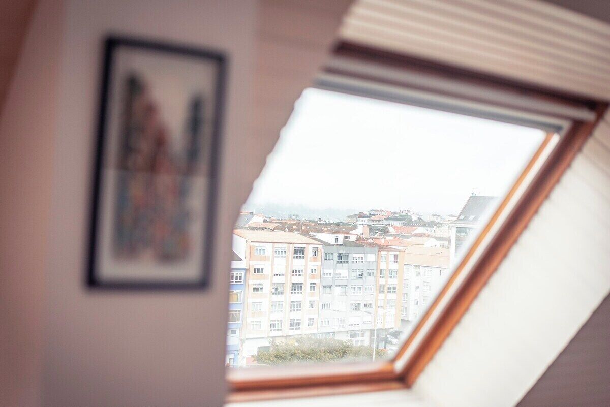 A view through a skylight of a residential area with multi-story buildings.