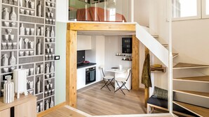A loft-style apartment with a kitchen, dining area, and a staircase. - The Green; Luxury Loft in the center of Milan (Milano)