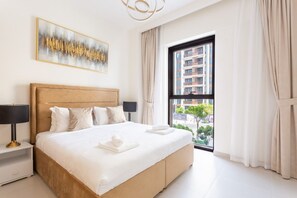 Une chambre d’hôtel avec un grand lit, une table de chevet, une lampe, une fenêtre avec des rideaux et une vue sur la ville.
