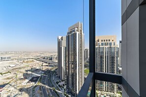A high-rise building with a modern architectural design, featuring multiple floors and a prominent central tower.