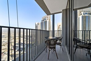 A balcony with a view of high-rise buildings and a construction site.
