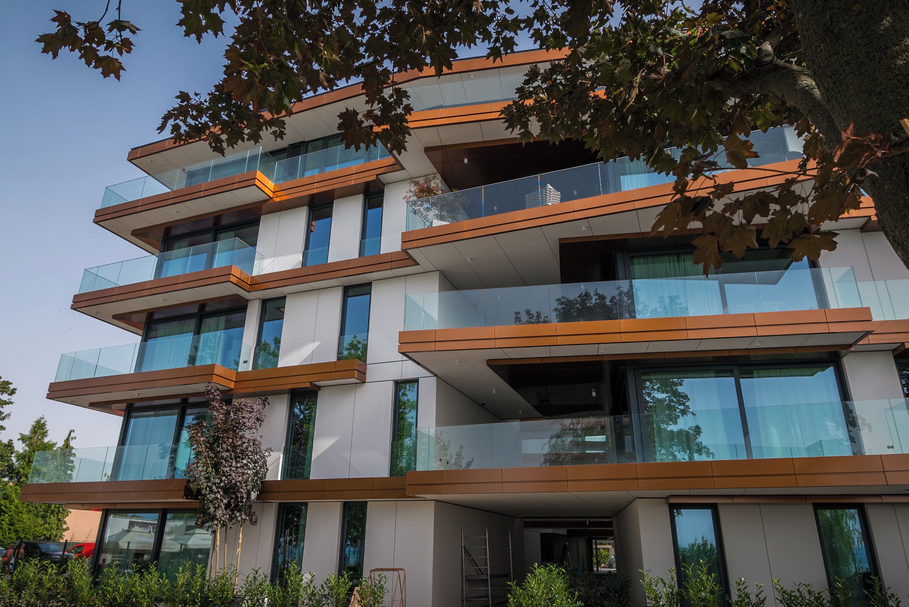 A multi-story building with balconies and large windows.