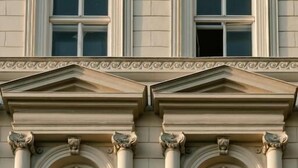 A building facade with symmetrical windows, decorative moldings, and classical architectural elements. - HOTEL andrä (Salzburg)