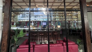 A bar with a glass front and a sign reading 'LUX Lounge and Bar'.
