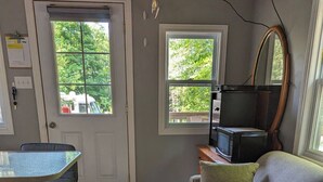 Ein gemütlicher, kompakter Wohnraum mit einer Couch, einem kleinen Tisch und einem Fernseher.