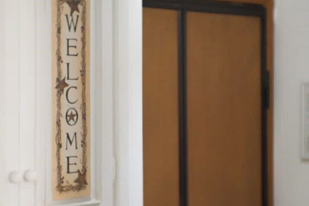 A door with a 'WELCOME' sign.