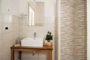 Bathroom features a white sink, mirror, and wooden vanity.