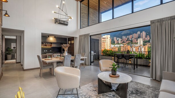 A spacious living area with a dining set, a sofa, and a view of a cityscape through large windows. - Luxe & bright ap in poblado /AC - Morph1401 (Medellín)