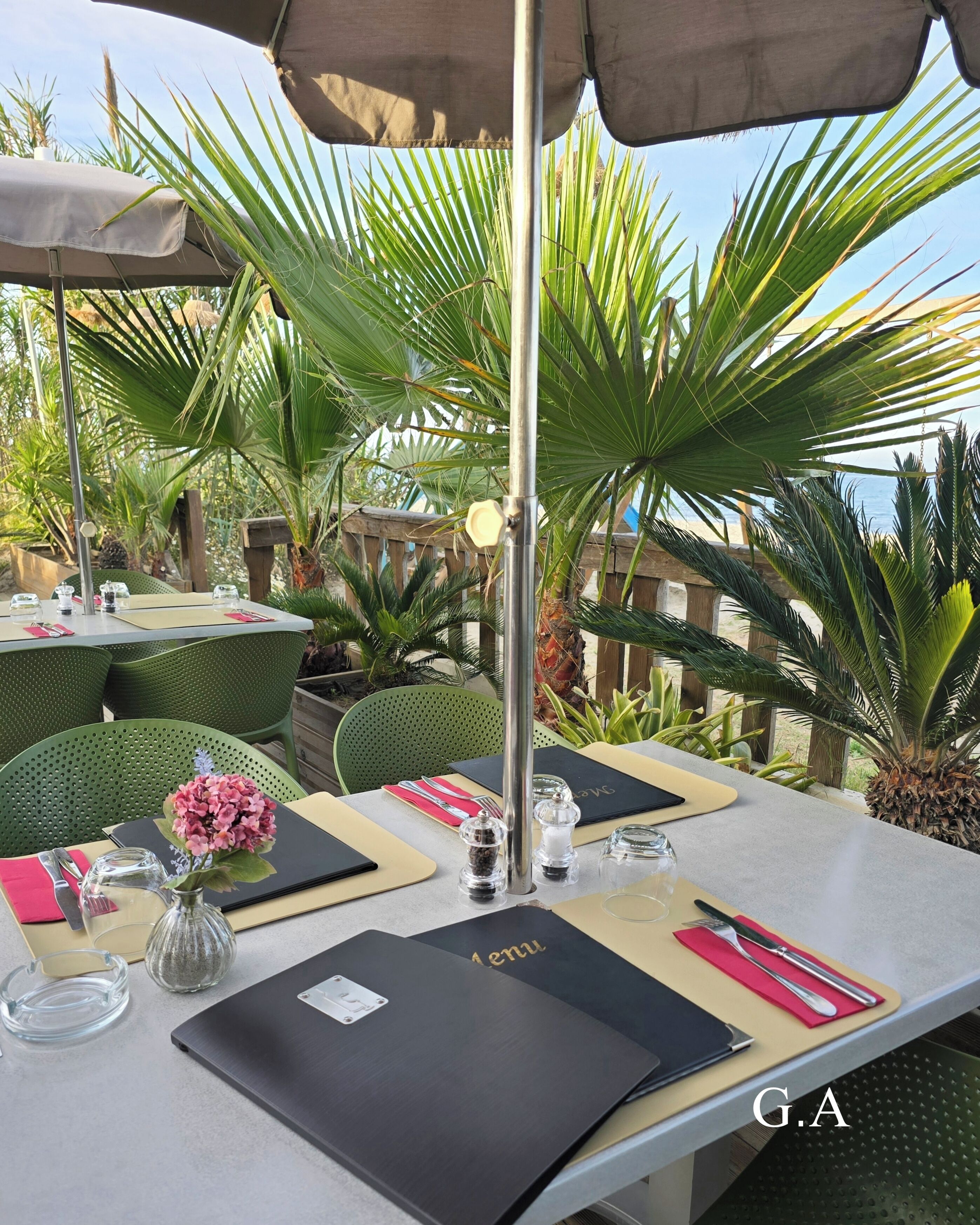 An outdoor dining area with tables, chairs, and umbrellas.