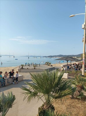 A beachside café with outdoor seating overlooking the sea.