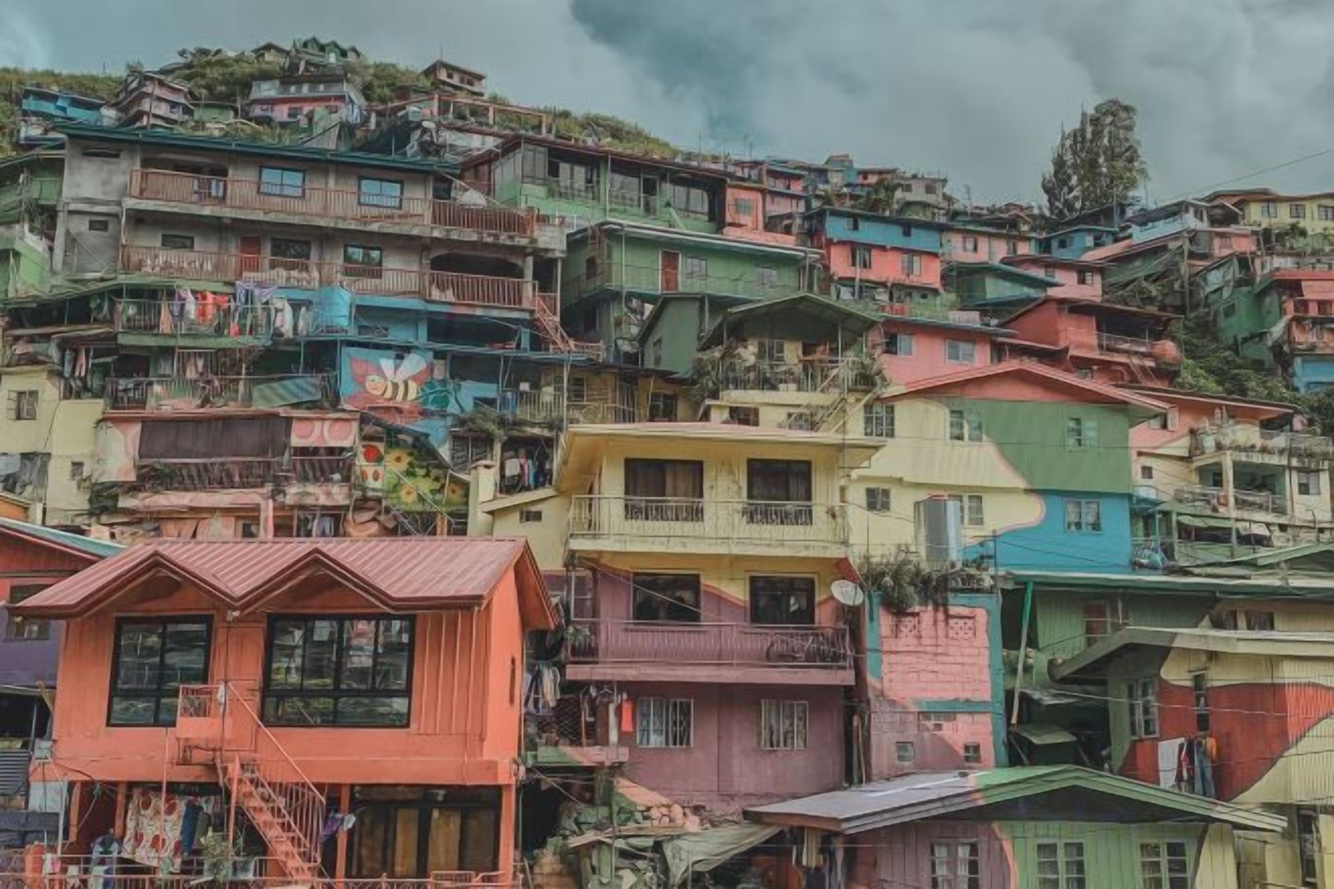 A densely packed hillside residential area with colorful houses.