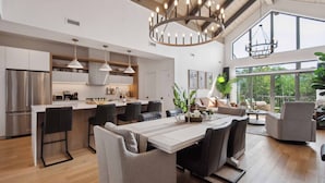 A spacious kitchen with a central island, modern appliances, and pendant lighting. - Tremblant Prestige - Verbier 11-204 (Mont-Tremblant)