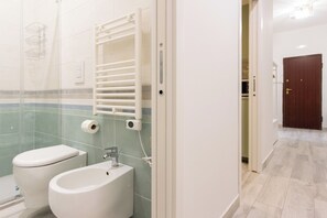 A bathroom with a toilet, bidet, and towel rack. - Ninetta a Foria - One Bedroom Apartment, Sleeps 4 (Naples)