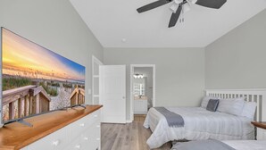 A bedroom with two beds, a TV, and a ceiling fan. - Beach & Golf Vacation 2 (Myrtle Beach)