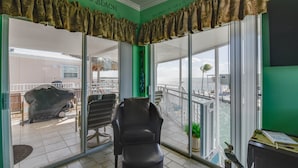 A room with a view of the sea, a covered car, and a chair. - Waterfront, Boat Dock, Heated Pool, Ocean Views #135 (Cudjoe Key)