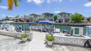 A marina with boats, a waterway, and a row of houses with balconies.