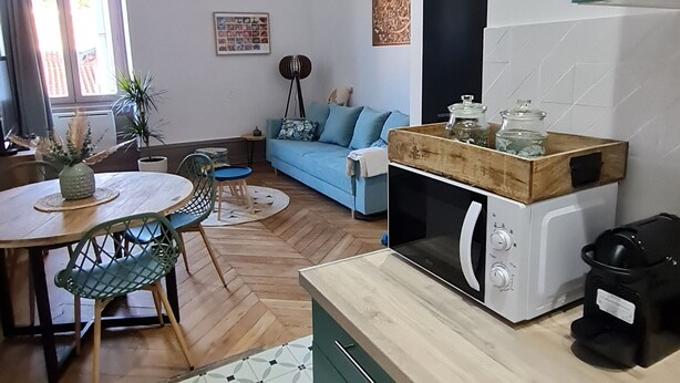 A compact living space with a kitchen, dining area, and seating area.
