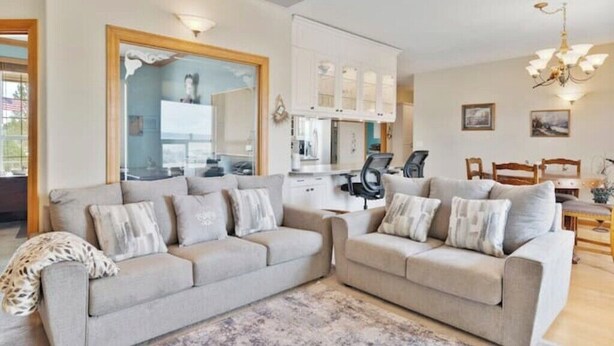 A modern living room with two sofas, a coffee table, and a dining area with chairs. - Central Oregon Outback Treasure
 (Silver Lake)