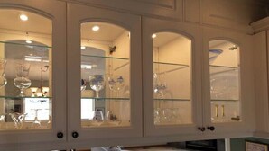 A room with arched glass cabinets displaying glassware. - Central Oregon Outback Treasure
 (Silver Lake)