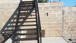A concrete staircase with metal railings leading up to a building. - Location de Courte Durée Studio Meublé (Le Trait)