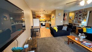 A compact living space with a kitchen, dining area, and a seating area with a couch and coffee table.