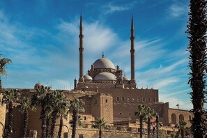 A mosque with two minarets and a large dome, surrounded by palm trees. - City Star Hotel (Cairo)