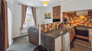 A compact kitchen with a built-in oven, a washing machine, and a small countertop. - Ideal for a Longer Stay or Contractor, Sleeps 1-4 (Cleckheaton)