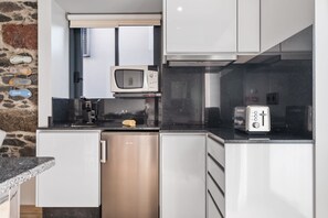Fridge, microwave, stovetop, coffee/tea maker