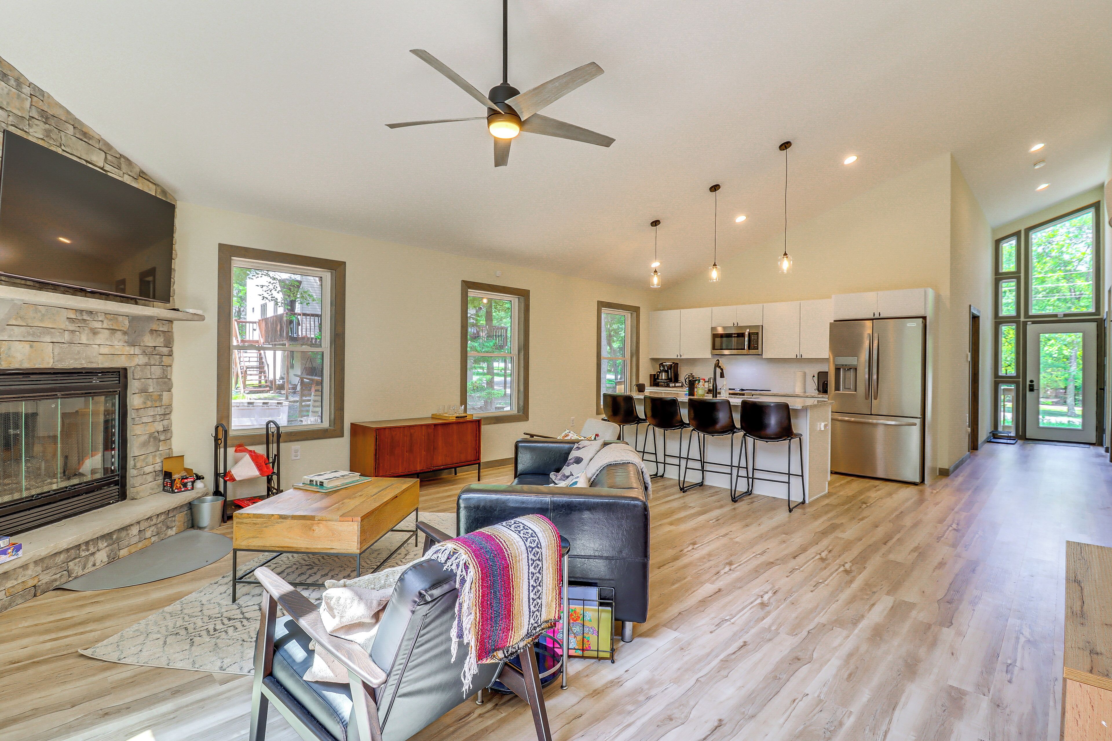 A spacious living area with a fireplace, a dining table, and a comfortable seating arrangement.