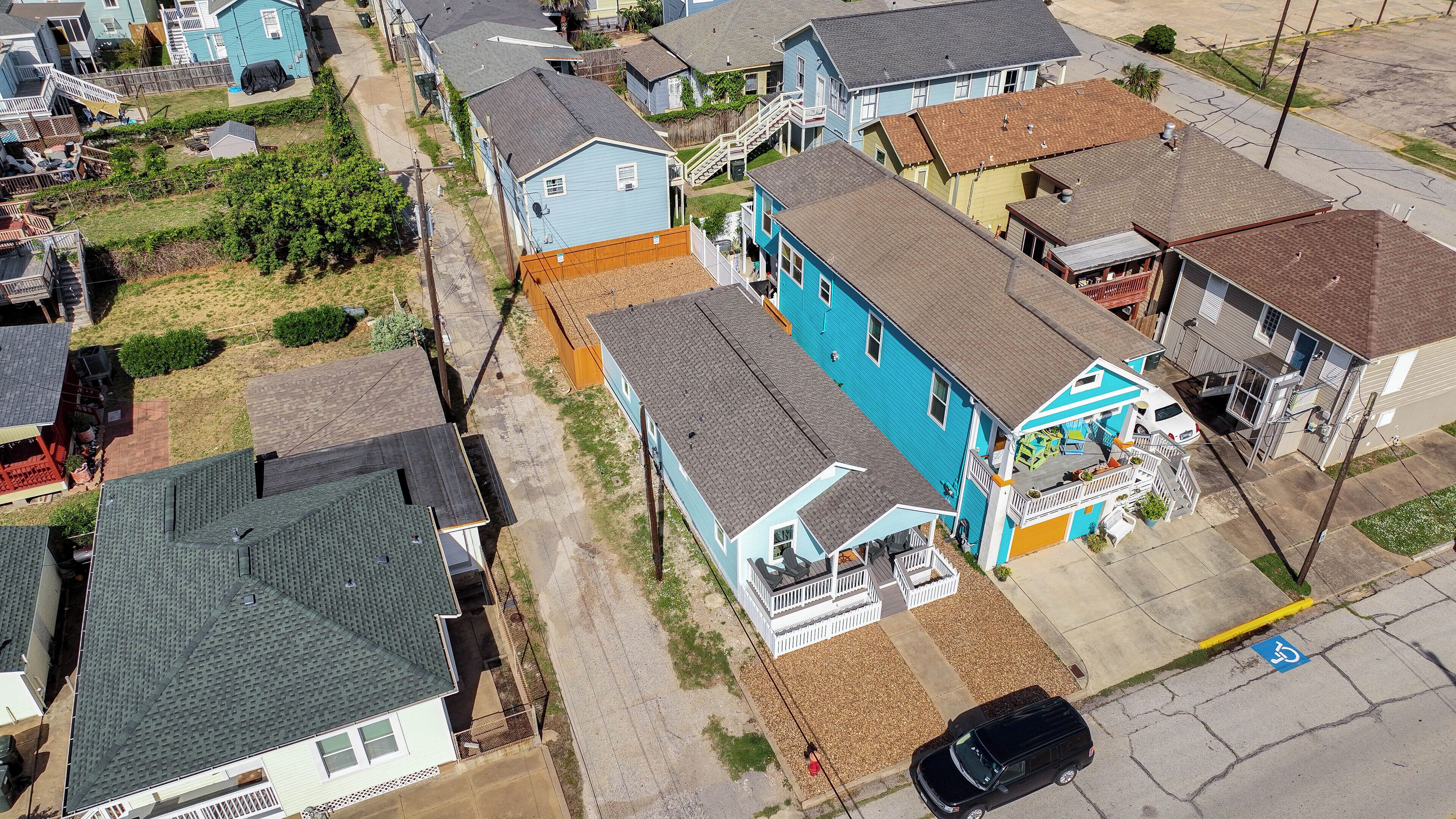 A residential area with houses, a driveway, and a parking space.
