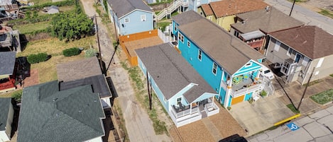 A residential area with houses, a driveway, and a parking space.
