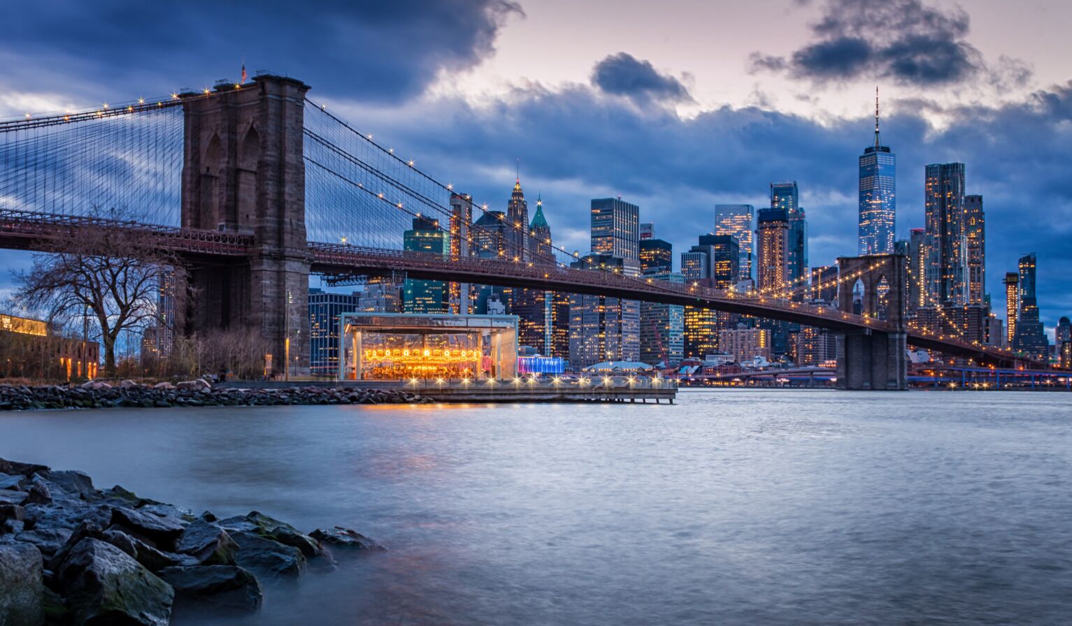 A city skyline with a prominent bridge and skyscrapers.