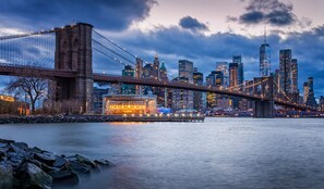 A city skyline with a prominent bridge and skyscrapers.