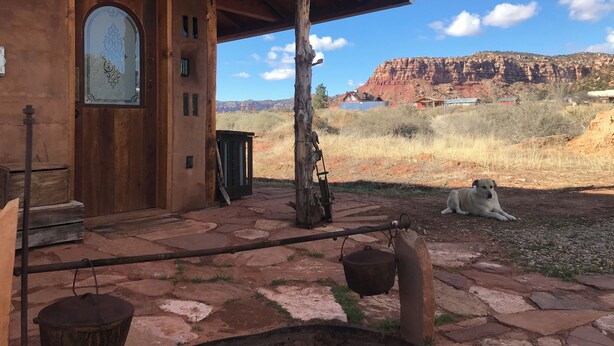 A rustic building with a stone-paved entrance and a wooden door. - 2 bedroom adobe home with AC, WiFi, great views, and new sauna and outdoor tub! (Cane Beds)