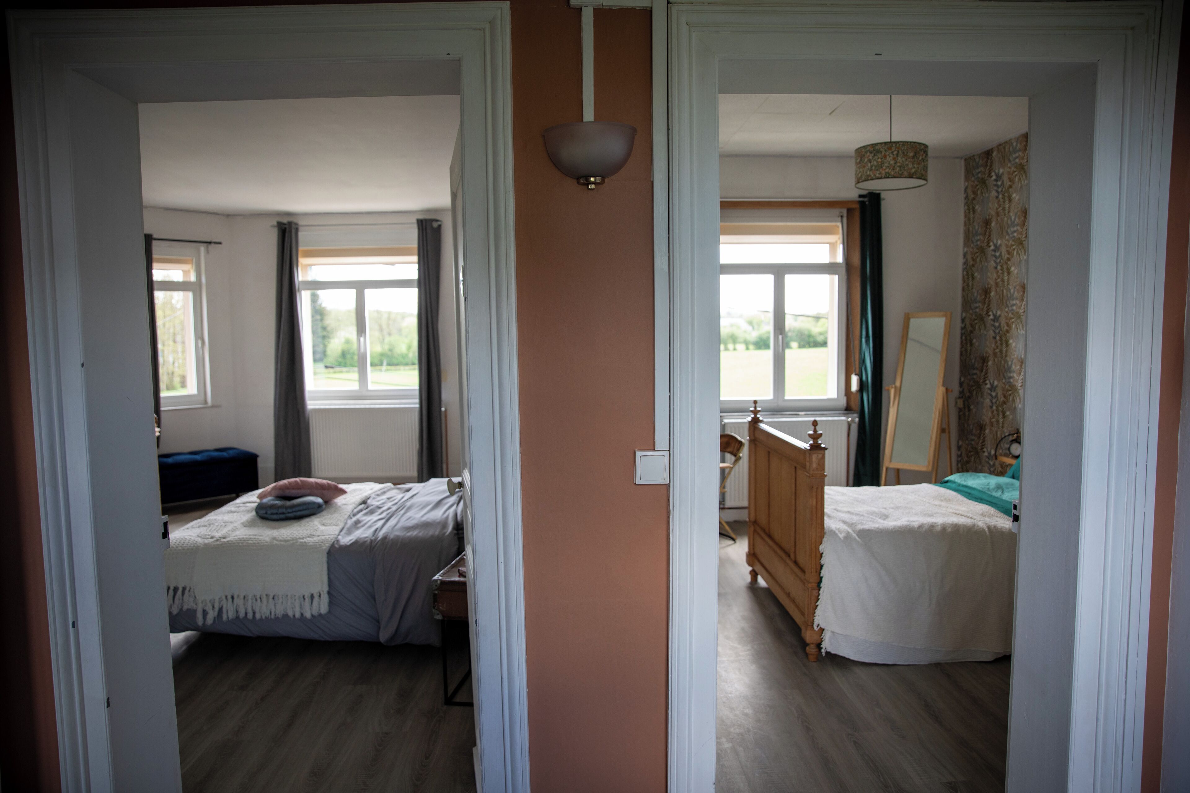 A bedroom with a bed, a dresser, and a window.