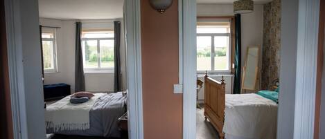 A bedroom with a bed, a dresser, and a window.