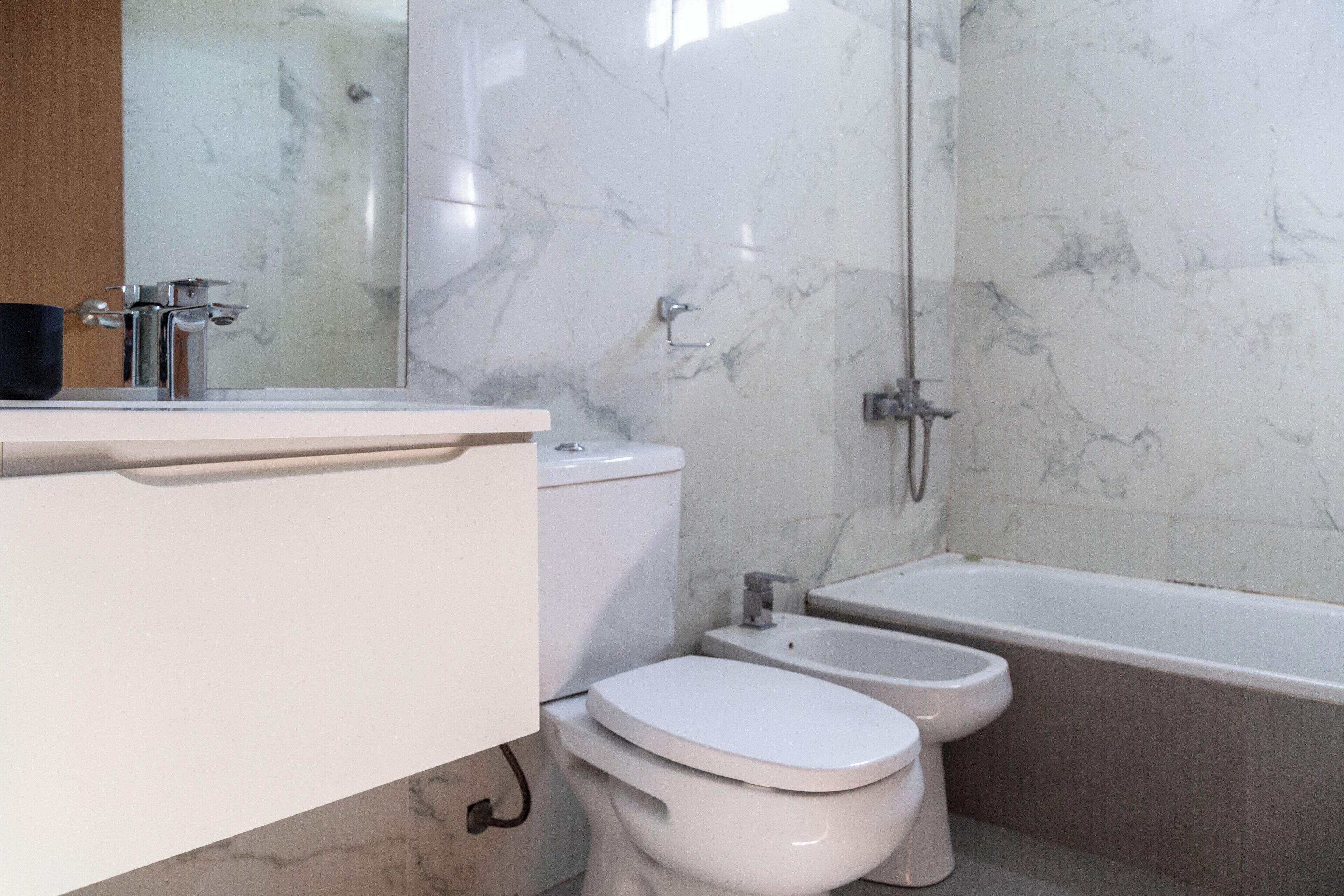 Un baño moderno con inodoro, bidé y bañera.