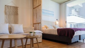A modern bedroom with a bed, a sofa, and a small table. - BT Homes - Palermo Fitz Roy (Buenos Aires)