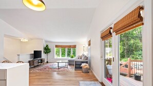A spacious living area with a sofa, TV, and a large window with blinds. - Scarborough Sanctuary-Cozy retreat close to all local attractions. (Scarborough)