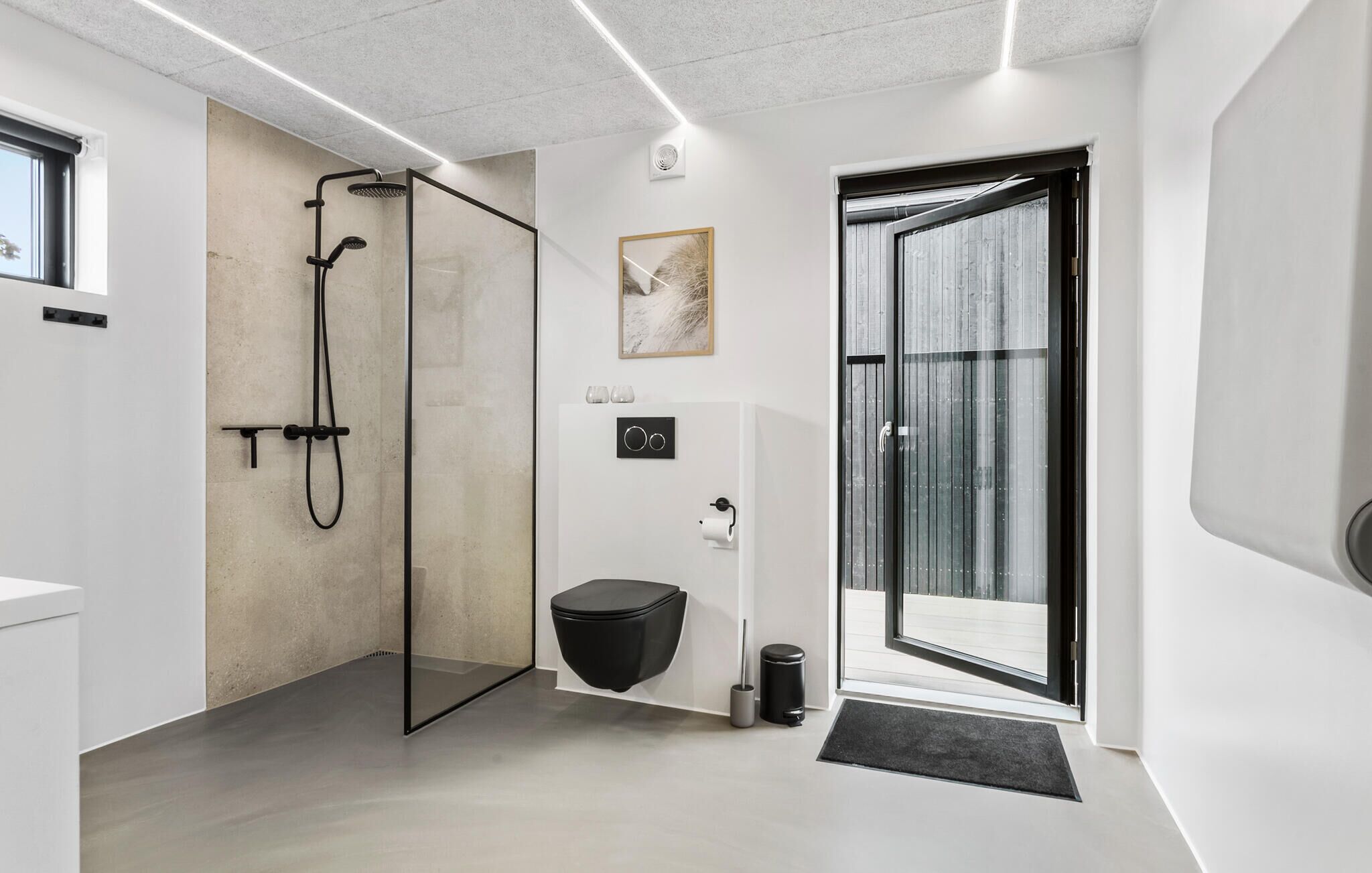 Een moderne badkamer met een douchecabine van glas, een toilet en een bidet.