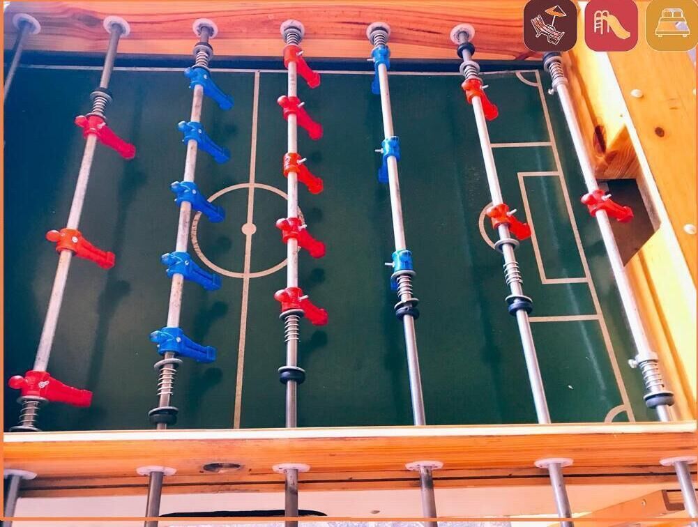 A foosball table with red and blue players.