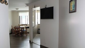 A hallway with a dining area, a blackboard, and a framed picture on the wall. - BEAUTIFUL APARTMENT IN THE BEST SECTOR OF QUITO (Quito)