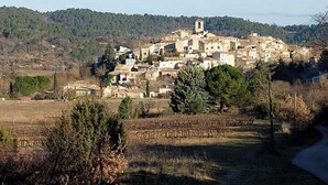 A village with traditional architecture, a prominent church tower, and a hilly backdrop. - House in Provence  (Pertuis)
