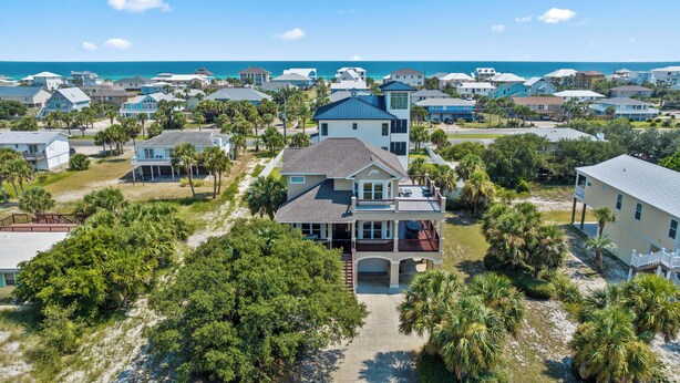A coastal residential area with houses featuring balconies and a view of the ocean.
