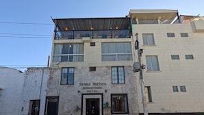 A two-story building with a sign reading "TERRA MISTICA MONASTERIO HOTEL". - Hotel TerraMistica Monasterio  (Arequipa)